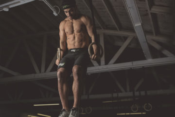 Man Performing Muscle Ups at CrossFit Open